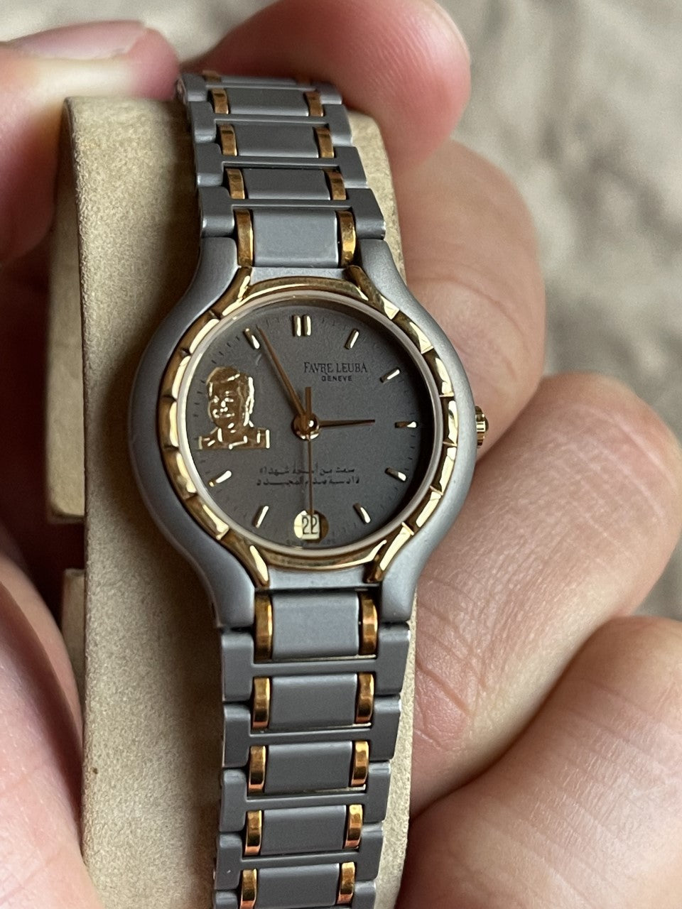 Two-tone steel women's watch with portrait dial held in hand