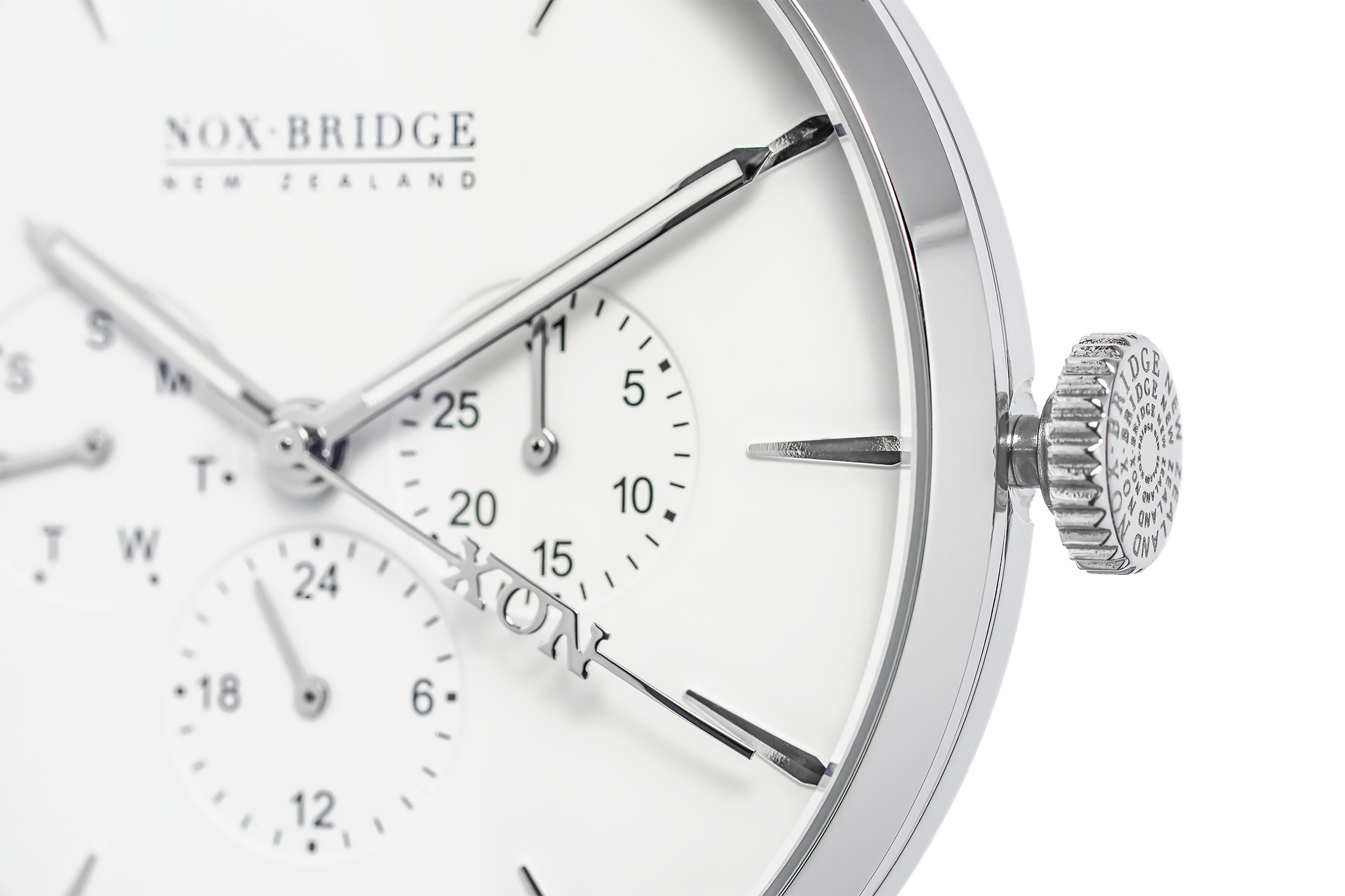 Close-up of Alcyone watch dial showing subdials, applied indices, and textured crown