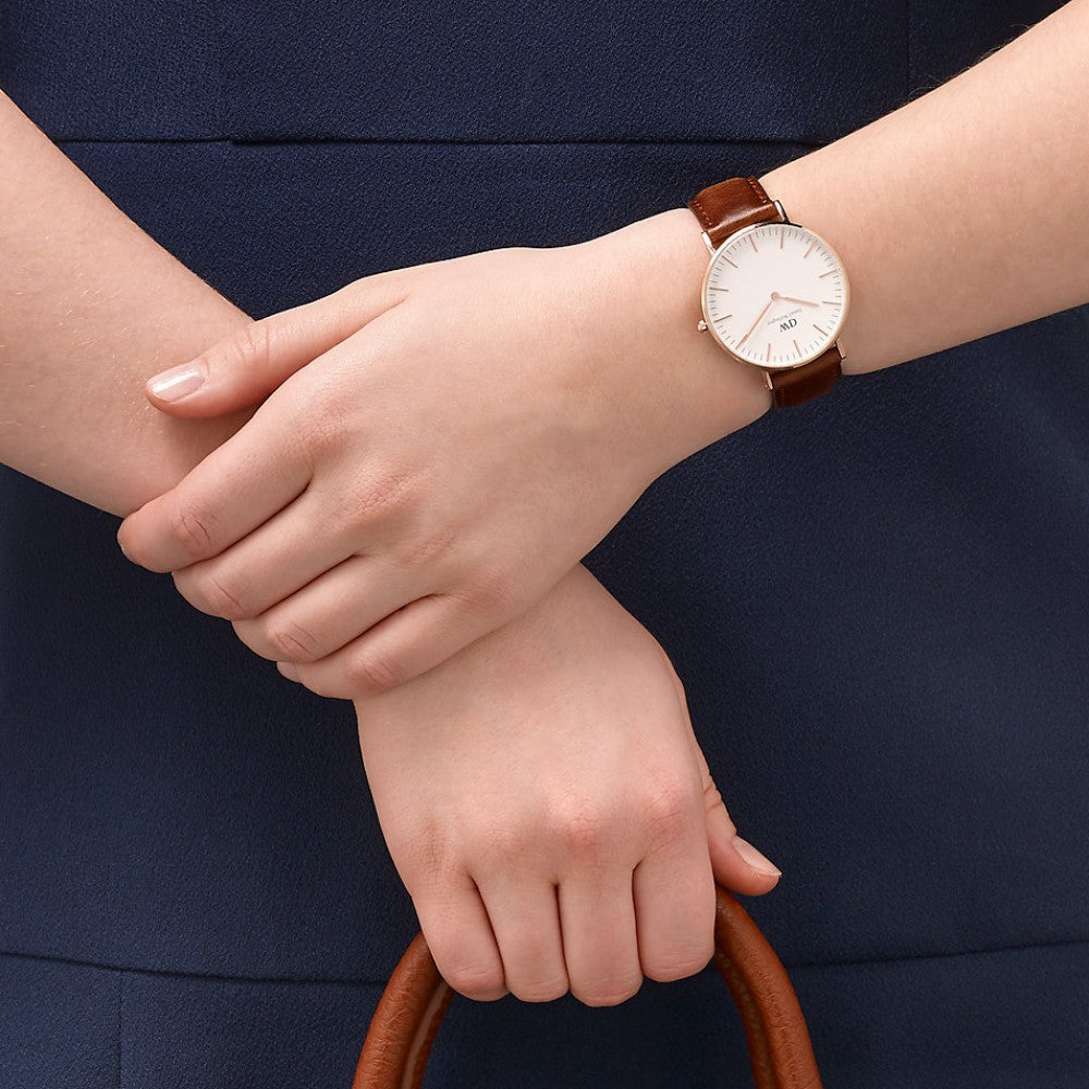 St Mawes 36mm watch on wrist showing minimalist white dial and brown leather band