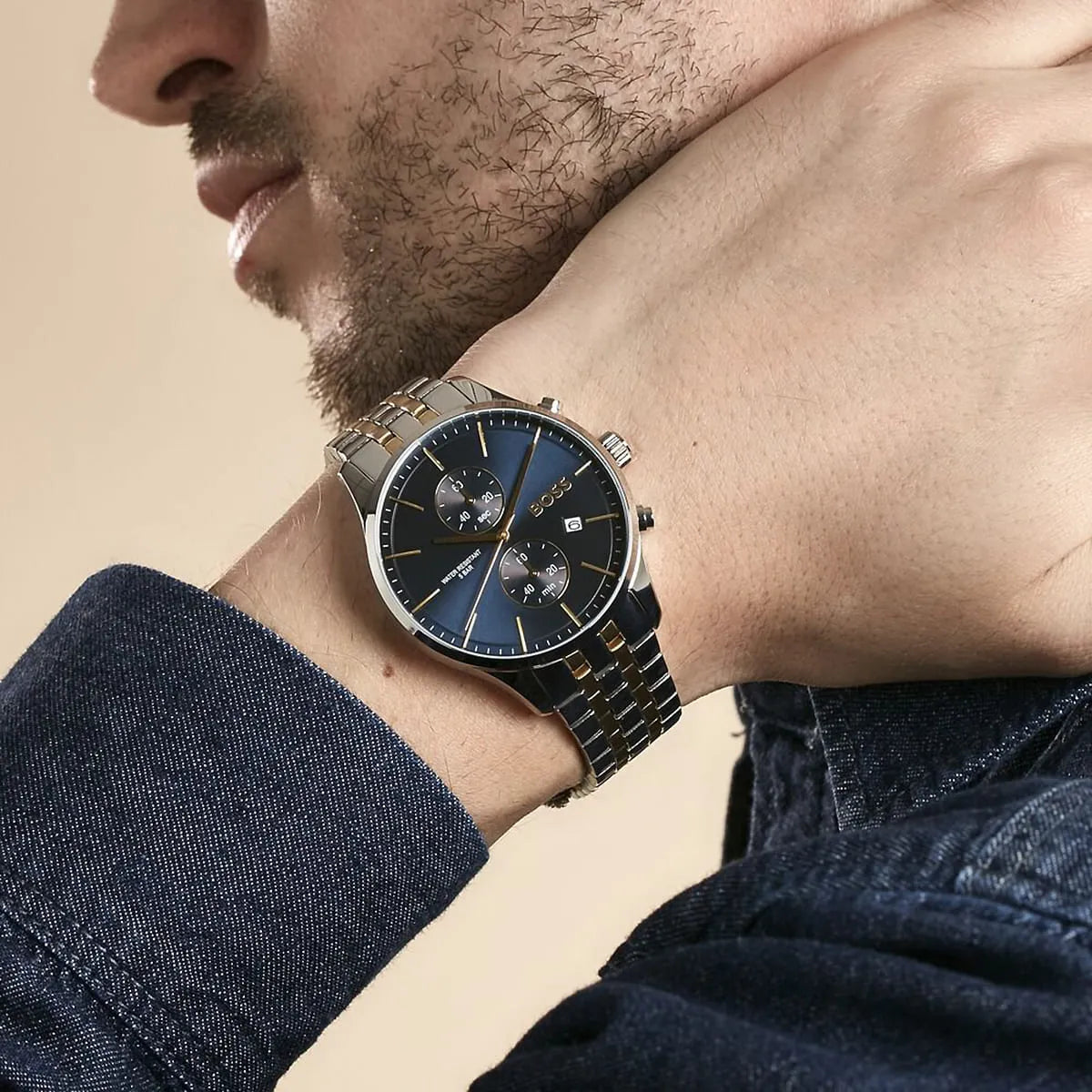 Hugo Boss Associate chronograph watch worn on wrist showing side profile and two-tone metal strap