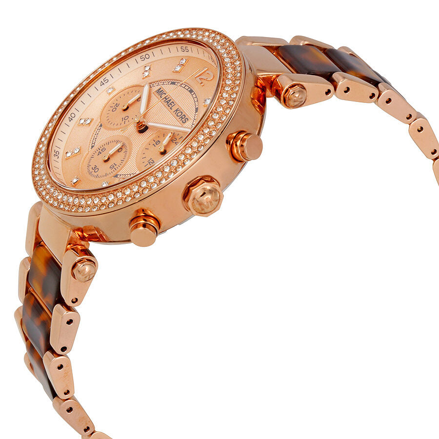 Michael Kors Parker watch angled view showing rose-gold case, chronograph subdials, and tortoise acetate bracelet