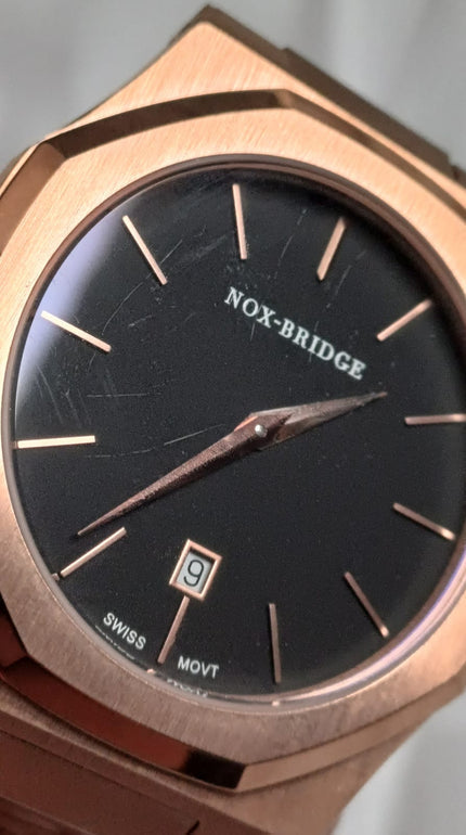 Noxbridge ECC40RG dial detail showing black face, rose gold indices, and date window