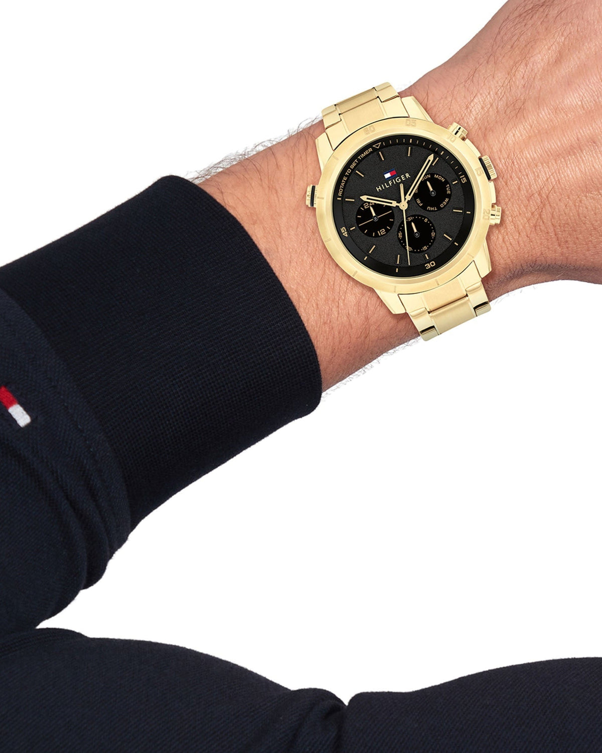 Tommy Hilfiger Troy chronograph watch on wrist showing black dial and gold case details